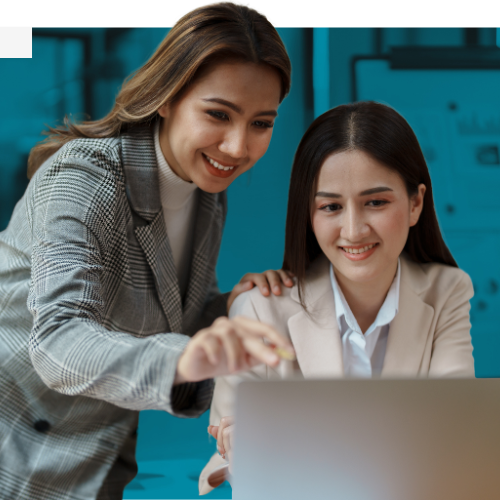 Two colleagues looking at a laptop together