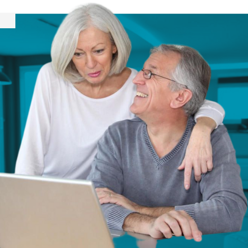 Retired couple smiling together at a laptop
