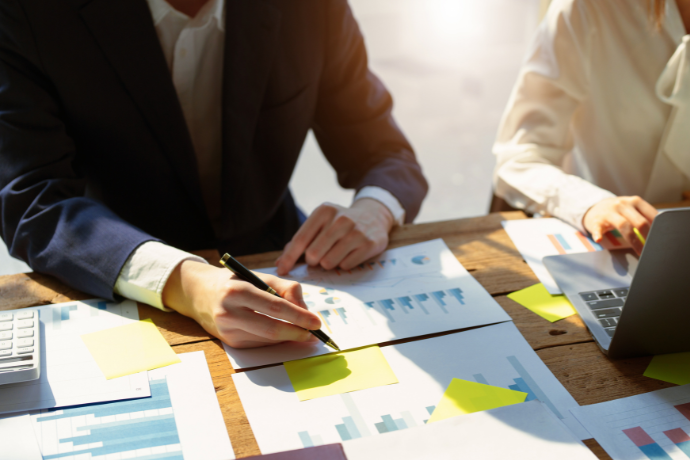 Business people reviewing charts at a meeting table