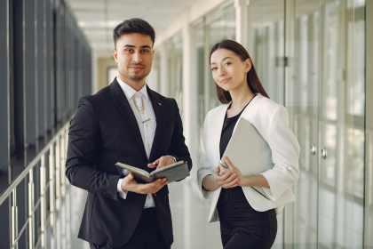 Two colleagues talking in an office corridor