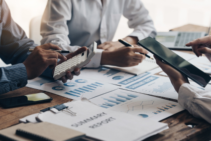 Colleagues reviewing financial reports at a desk