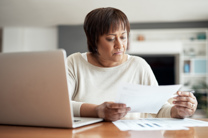Woman reviewing a document at her laptop