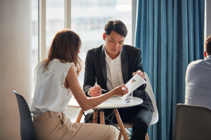 Adviser meeting a client at an office desk